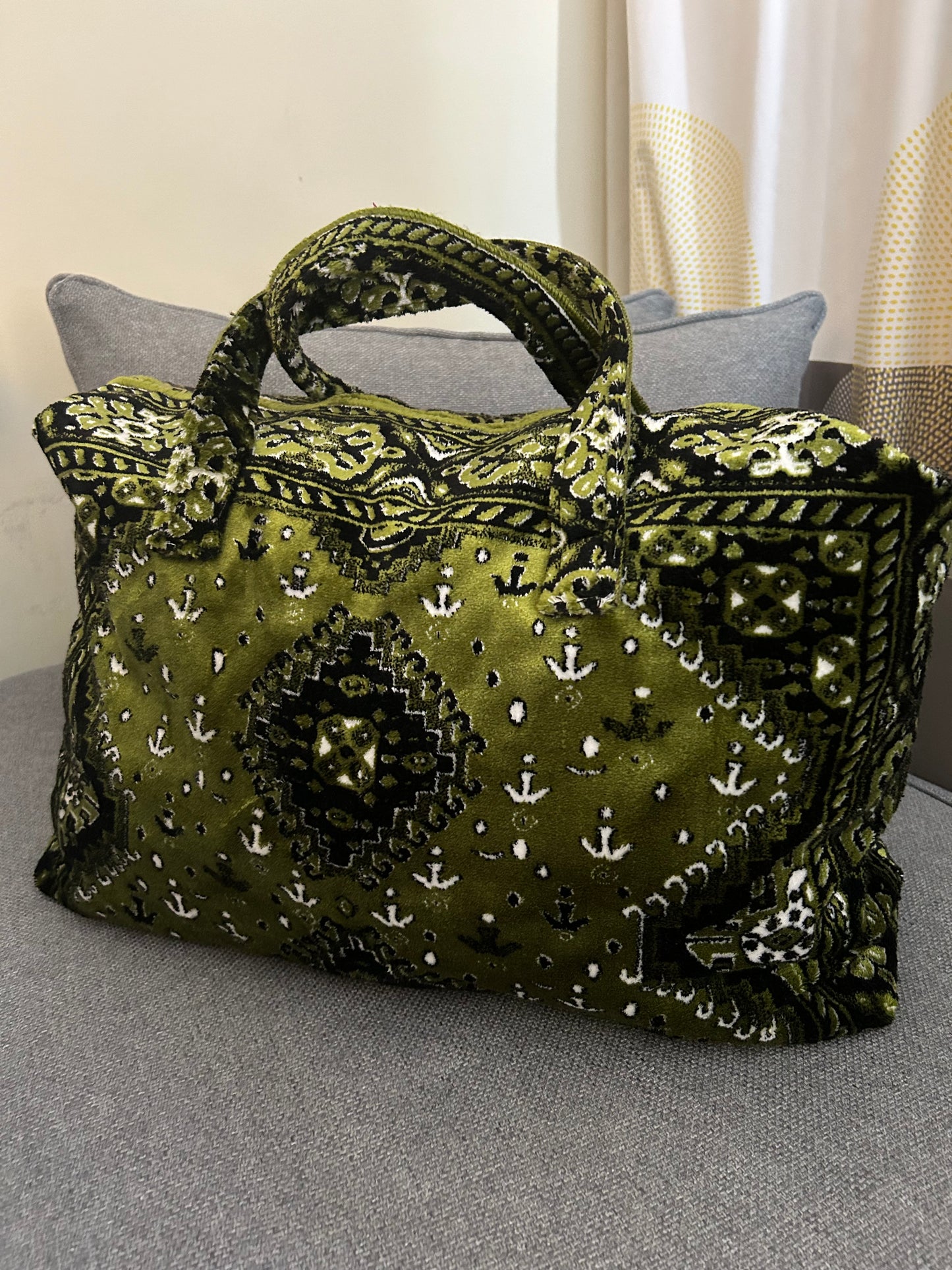 Weekend bag made of carpet fabric in olive green color with white