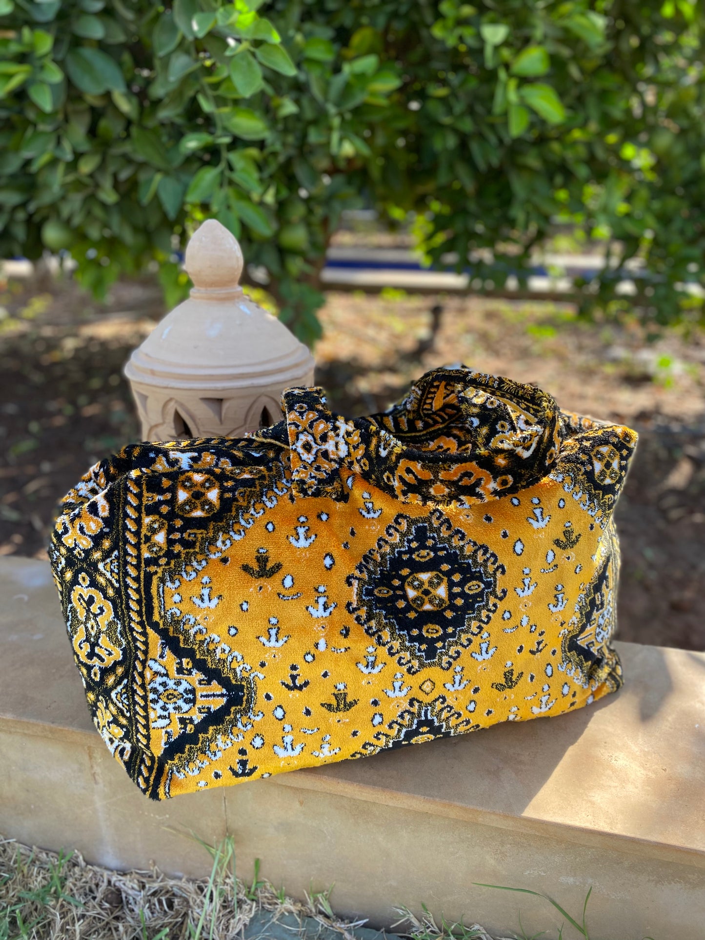 Weekend bag made of carpet fabric in golden yellow color with black