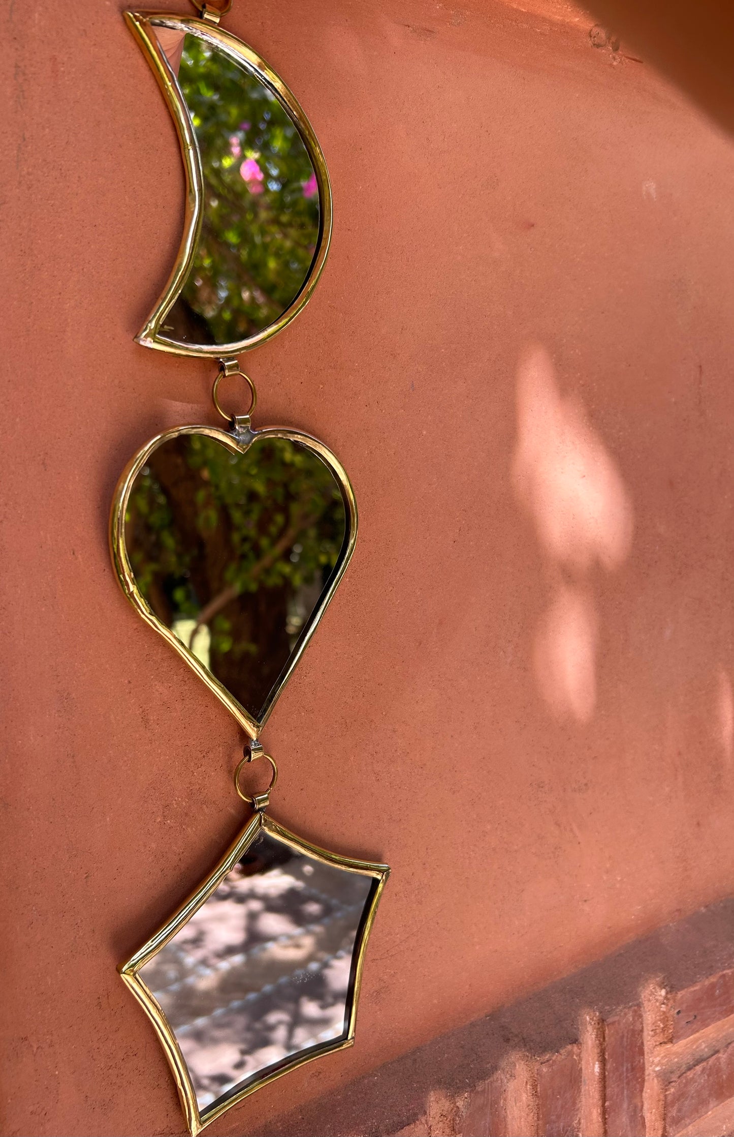 Garland of handmade brass mirrors, moon, heart, star