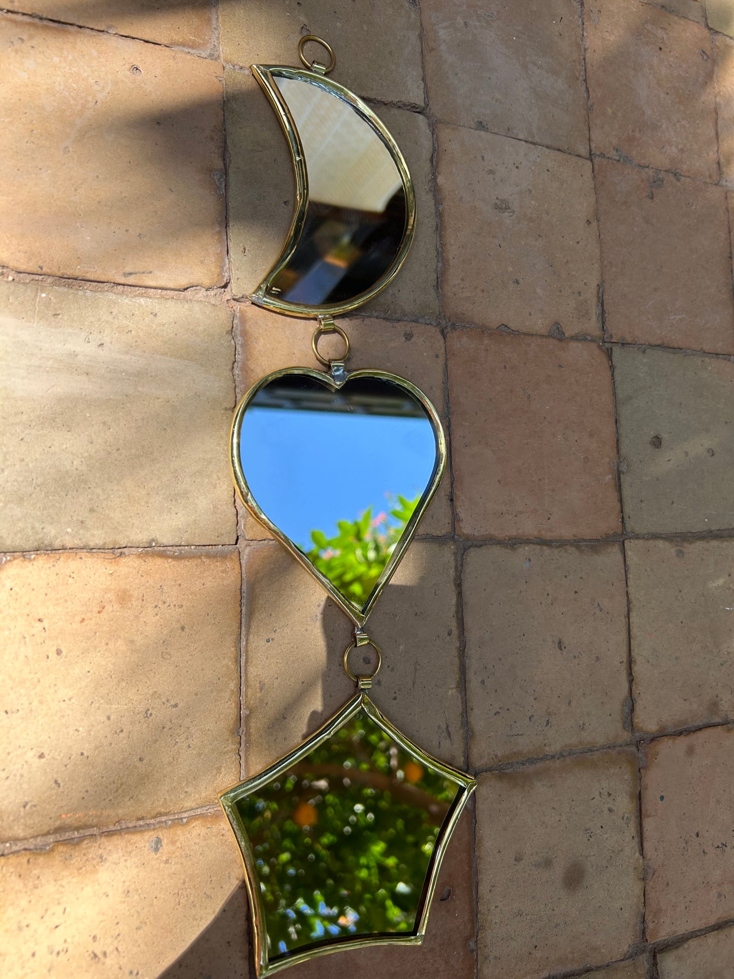 Garland of handmade brass mirrors, moon, heart, star
